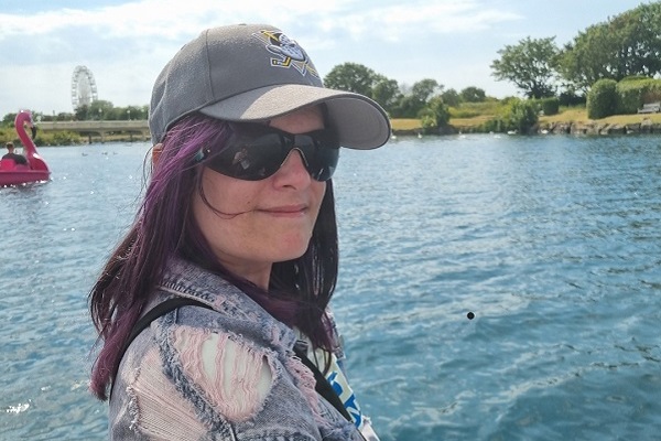 Close up of a woman smiling sitting on a boating lake boat