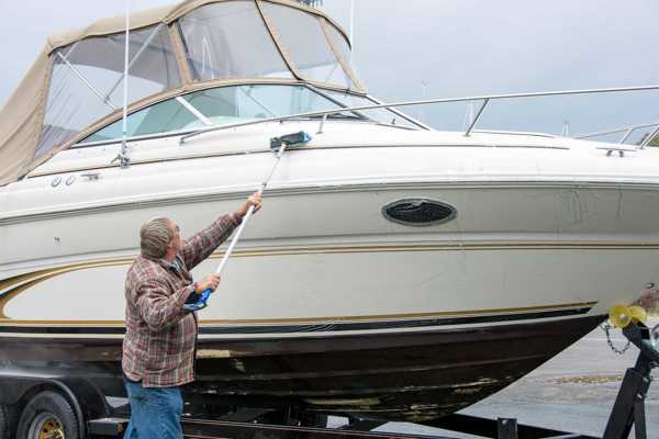 man cleaning a boat