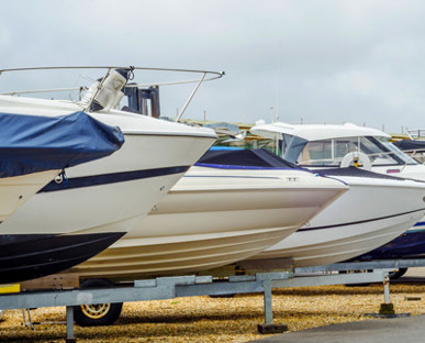 Staggered Prows Of Yachts On Boat Stands And Gravel