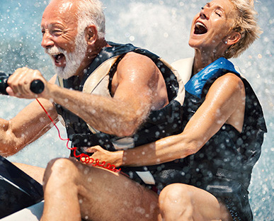 Laughing Seniors On A Splashing Jetski