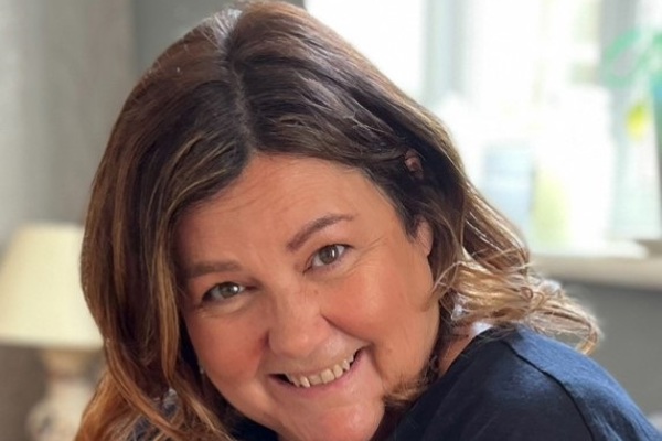 Close up of a smiling lady with chestnut hair